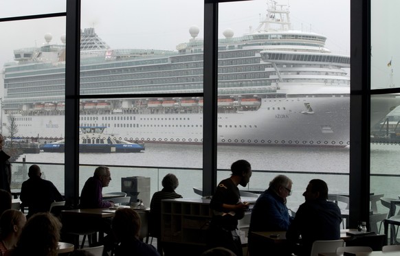 FILE - The Italian-built cruise ship MS Azura sails past the EYE film institute as it leaves the port of Amsterdam, Netherlands, Jan. 9, 2013. Amsterdam municipality wants to move a cruise liner termi ...