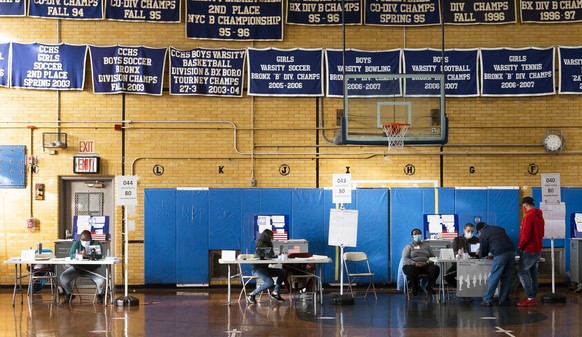 epa08797128 Polling site workers are seen at a polling site at Bronxdale High School in the Bronx, New York, USA, 03 November 2020. Americans vote on Election Day to choose between re-electing Donald  ...