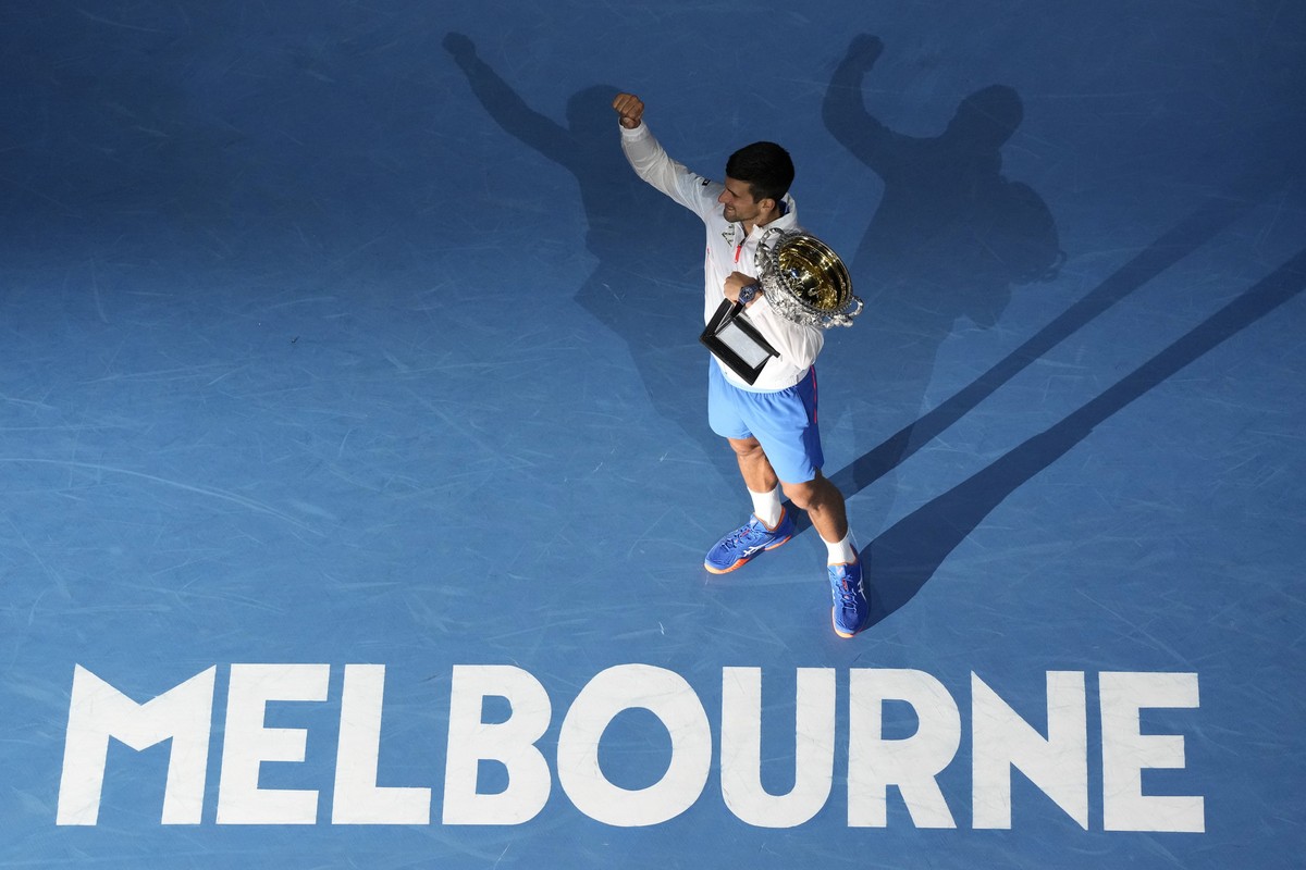 Novak Djokovic of Serbia reacts as he holds the Norman Brookes Challenge Cup after defeating Stefanos Tsitsipas of Greece in the men's singles final at the Australian Open tennis championship in  ...