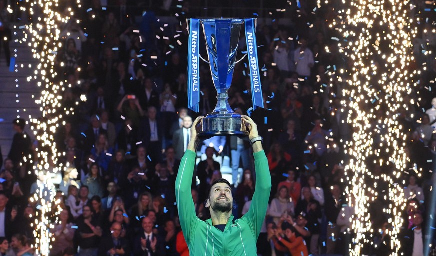 epaselect epa10985335 Novak Djokovic of Serbia poses with the trophy after winning his singles finals match against Jannik Sinner of Italy at the Nitto ATP Finals tennis tournament in Turin, Italy, 19 ...