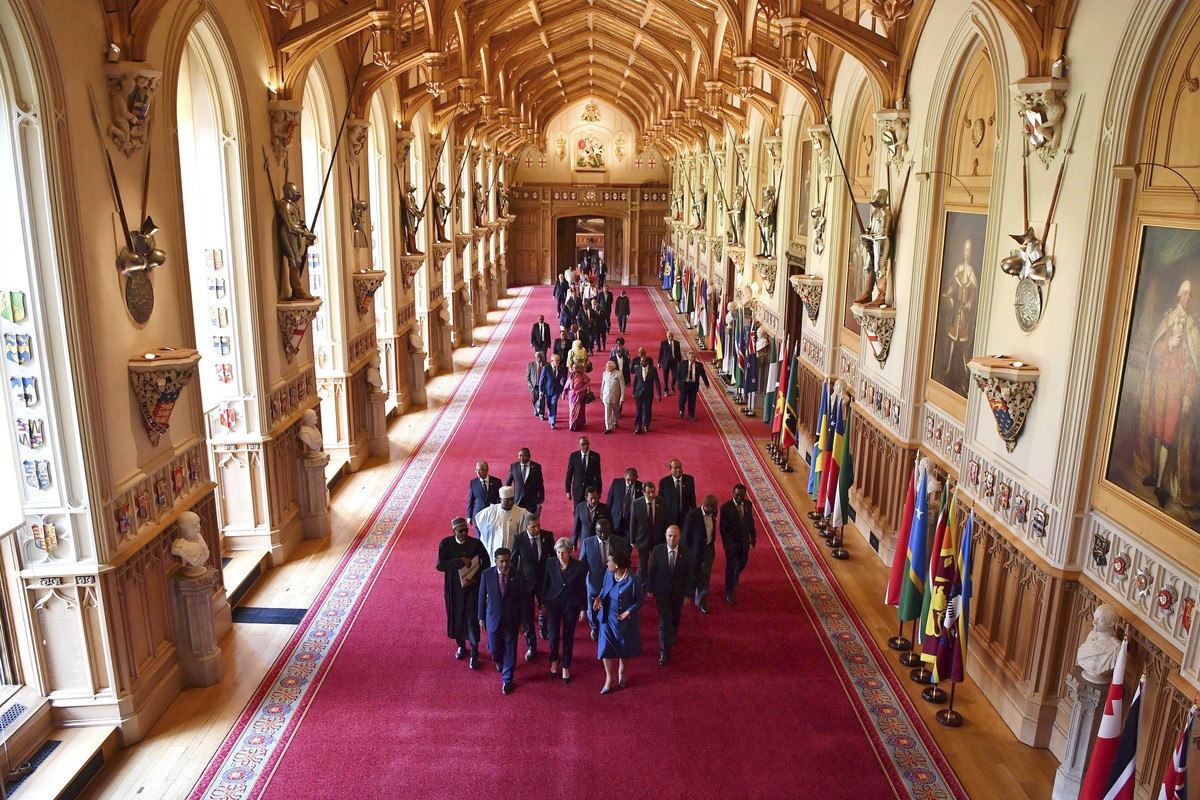 Britain's Prime Minister Theresa May, front centre, leads other leaders of the Commonwealth nations through St George's hall at Windsor castle, during the CHOGM Commonwealth Heads of Governm ...