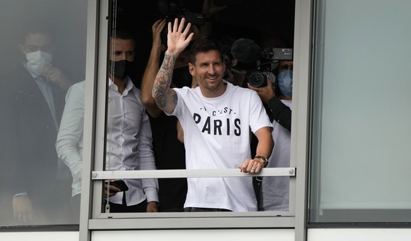 Lionel Messi waves after arriving at Le Bourget airport, north of Paris, Tuesday, Aug. 10, 2021. Lionel Messi finalized agreement on his Paris Saint-Germain contract and was flying to France on Tuesda ...