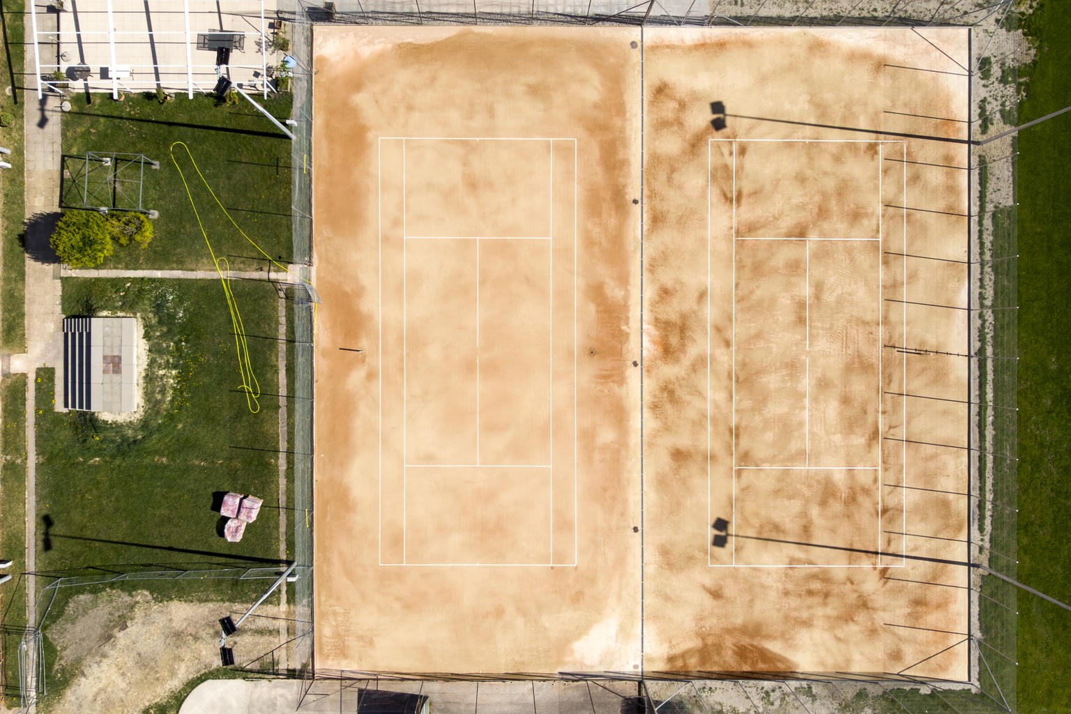 Empty clay tennis courts are pictured without players while they are closed due to the state of emergency of the coronavirus disease (COVID-19) outbreak, in Yverdon-les-bains, Switzerland, Wednesday,  ...