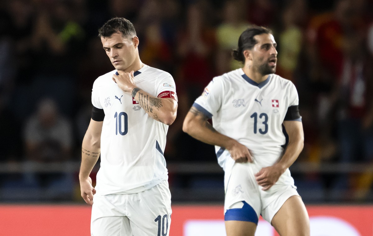 epa11728236 Switzerland players Granit Xhaka (L) and Ricardo Rodriguez after losing the UEFA Nations League soccer match between Spain and Switzerland in Santa Cruz de Tenerife, Spain, 18 November 202 ...