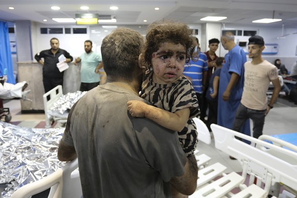 Wounded Palestinians arrive at the al-Shifa hospital, following Israeli airstrikes on Gaza City, central Gaza Strip, Thursday, Oct. 19, 2023. (AP Photo/Abed Khaled)