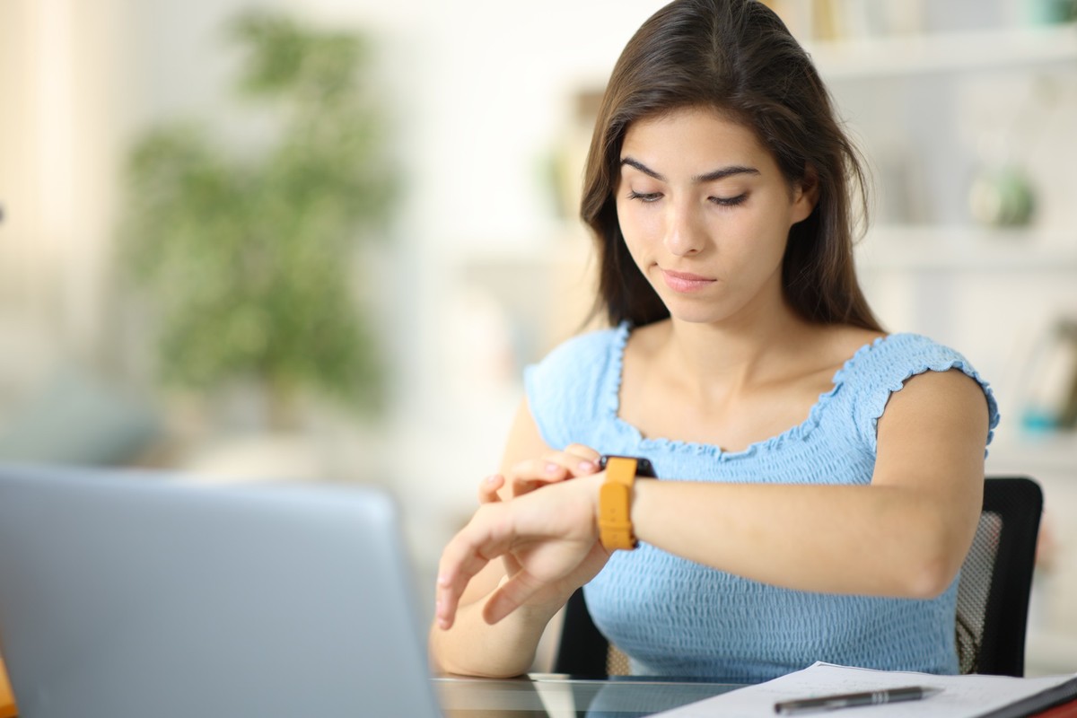 Suspicious woman checking smartwatch at home, Suspicious woman checking smartwatch content sitting at home, Suspicious woman checking smartwatch content sitting at home model released, Symbolfoto , 18 ...