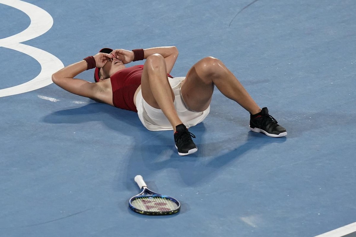 Belinda Bencic, of Switzerland, reacts after defeating Marketa Vondrousova, of the Czech Republic, in the women's gold medal match of the tennis competition at the 2020 Summer Olympics, Saturday, ...