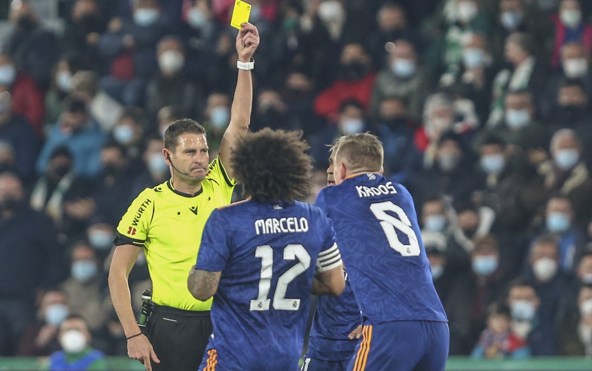 Referee shows a yellow card to Real Madrid's Toni Kroos during a Copa del Rey soccer match between Elche and Real Madrid at Martinez Valero stadium in Elche, Spain, Thursday, Jan. 20, 2022. (AP P ...