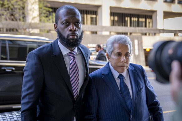 FILE - Prakazrel &quot;Pras&quot; Michel, left, a member of the 1990s hip-hop group the Fugees, accompanied by defense lawyer David Kenner, right, arrives at federal court for his trial in an alleged  ...