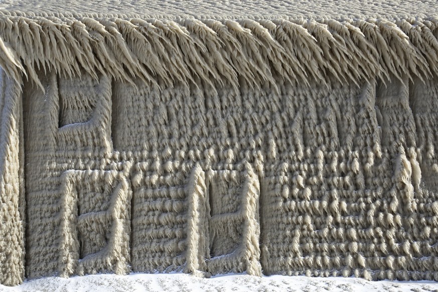 A house along Hoover Beach is covered by ice from high winds and from the waves from Lake Erie, Saturday, Feb. 29, 2020, in Hamburg N.Y. Blowing snow has fallen around the state since Thursday, though ...