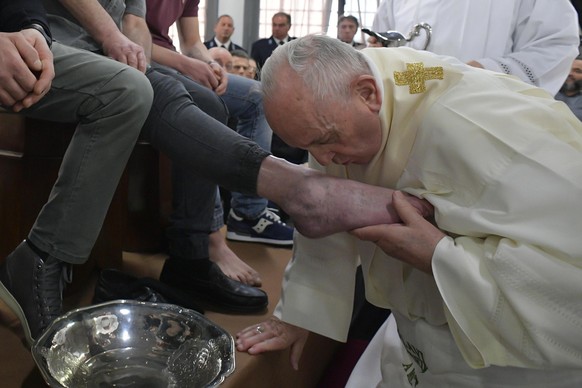 epa07514334 A handout picture provided by the Vatican Media shows Pope Francis washes the feet of inmates during his visit to the Velletri's prison where he celebrated the Mass in Coena Domini in ...