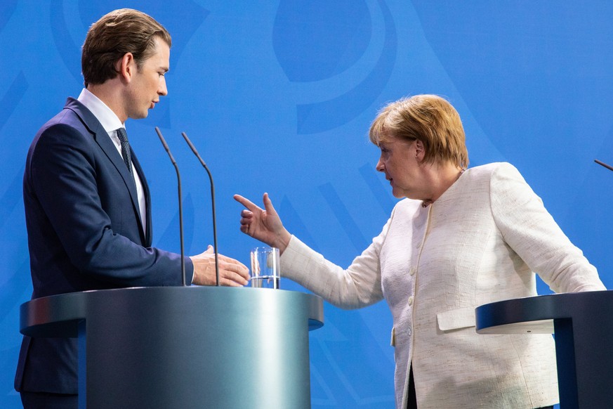 epa06803150 German Chancellor Angela Merkel (R) and the Austrian Chancellor Sebastian Kurz (L) arrive to a joint press conference following a meeting at the chancellery in Berlin, Germany, 12 June 201 ...