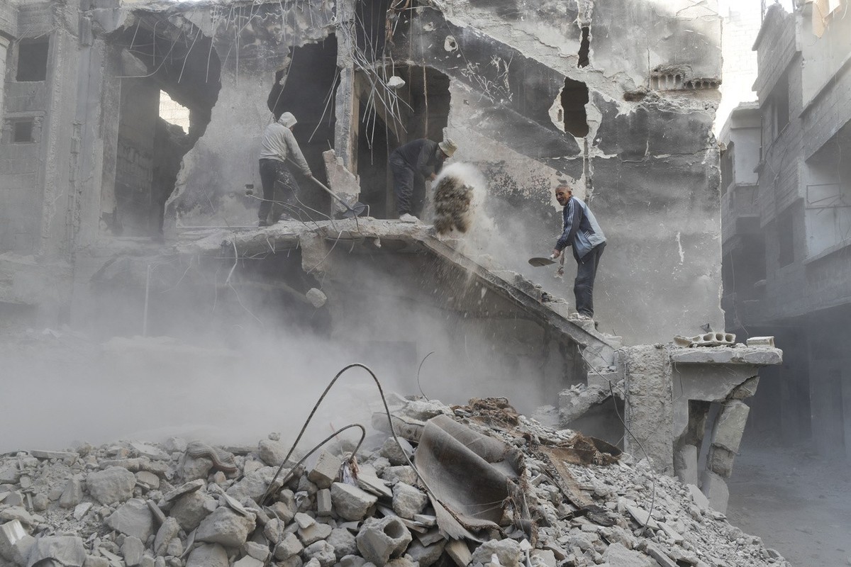 Workers clean up destruction h Yarmouk camp in Damascus Syria that has seen heavy fighting during the civil war, Wednesday, Nov. 2, 2022. (AP Photo/Omar Sanadiki)