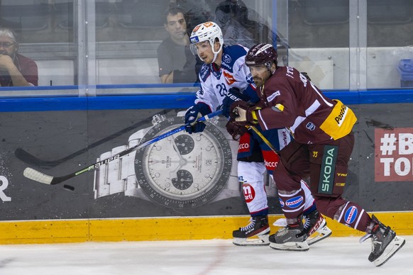 L&#039;attaquant des SZC Jesper Froeden, gauche, a la lutte pour le puck avec le defenseur genevois Arnaud Jacquemet, droite, lors du match du championnat suisse de hockey sur glace de National League ...