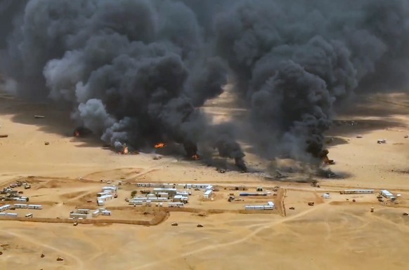 epa13220621 A handout screen grab taken from a video released on 07 September 2026 made available by the Houthi military media center shows smoke and balls of fire rising from trucks at a camp of the  ...