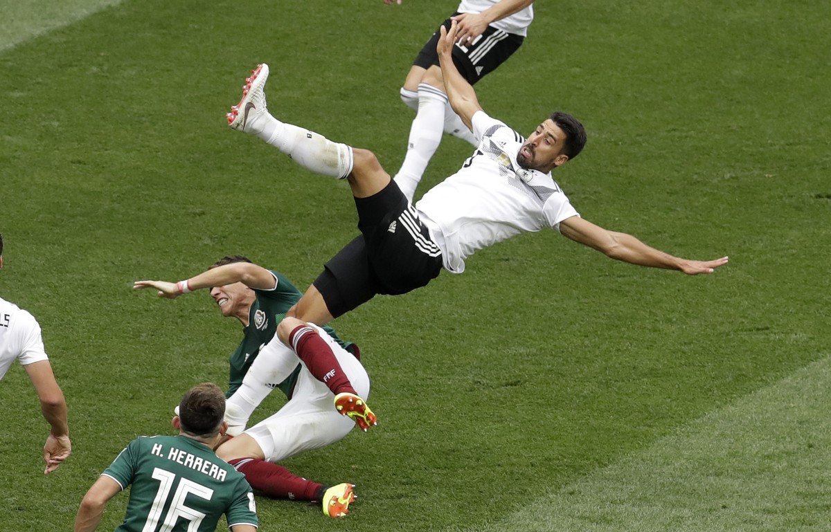 Germany's Sami Khedira falls over Mexico's Hector Moreno during the group F match between Germany and Mexico at the 2018 soccer World Cup in the Luzhniki Stadium in Moscow, Russia, Sunday, J ...