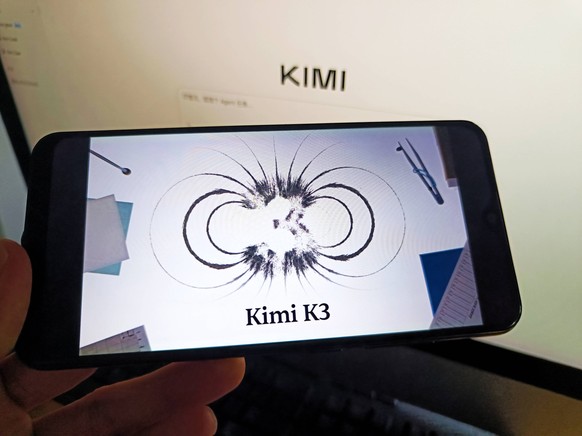 Moonshot AI Kimi K3 SUQIAN, CHINA - JULY 17, 2026 - A netizen is using his mobilephone to view Kimi K3 logo and using his computer to view Kimi K3 webpage in Suqian, Jiangsu, China on July 17, 2026. S ...
