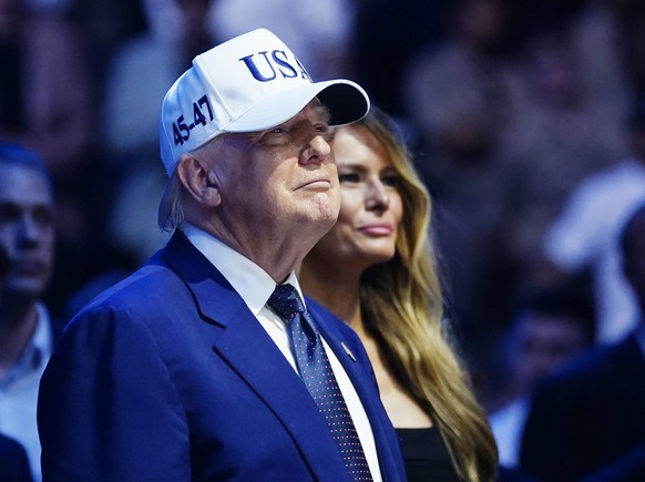 epa13038087 US President Donald Trump (L) and First Lady Melania Trump (R) watch as Justin Gaethje defeats Ilia Topuria for the UFC Lightweight title at the UFC Freedom 250 event on the South Lawn of  ...