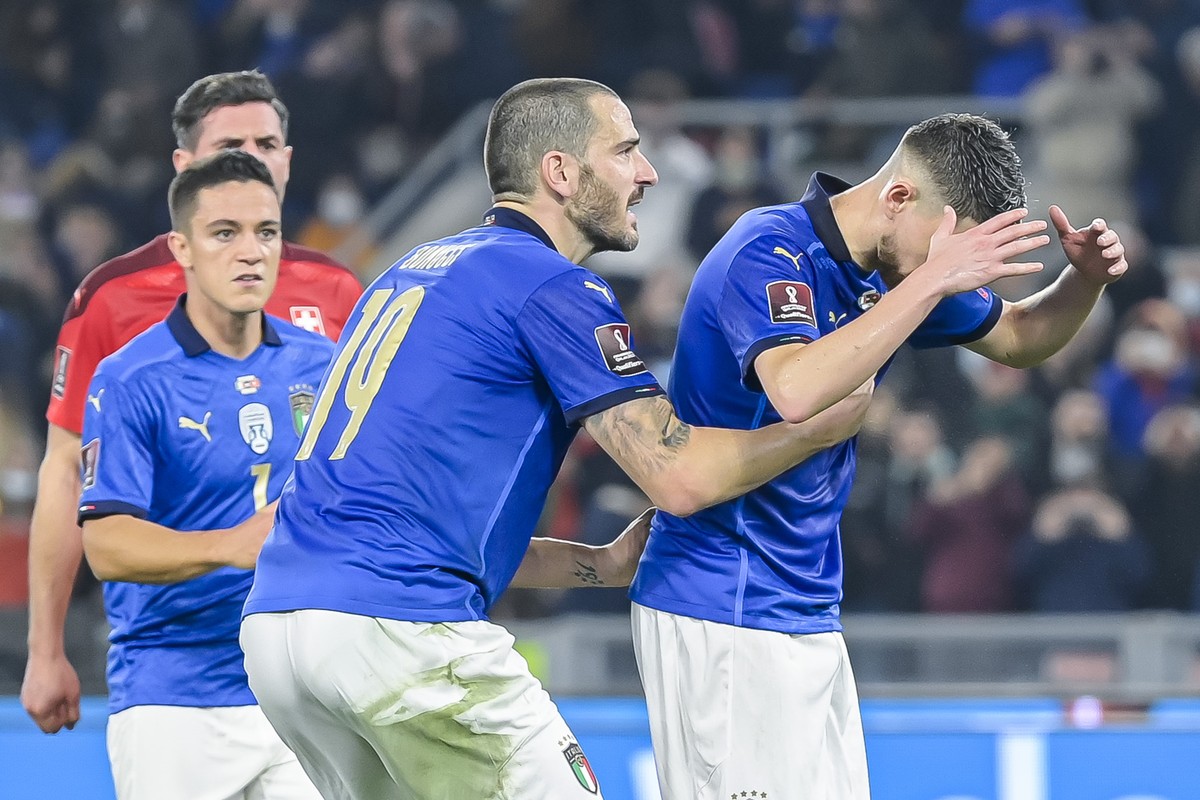 Italy's midfielder Jorge Luiz Frello Filho "Jorginho", right, reacts, after he missed a penalty next to Italy's defender Leonardo Bonucci, center, during the 2022 FIFA World Cup Eu ...