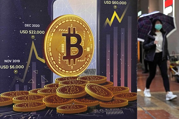 FILE - An advertisement for Bitcoin cryptocurrency is displayed on a street in Hong Kong, on Feb. 17, 2022. Bitcoin slumped to a two-year low, Wednesday, Nov. 9, and other digital assets sold off foll ...