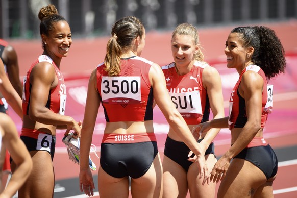 From left, Salome Kora, Riccarda Dietsche, Ajla Del Ponte, and Mujinga Kambundji of Switzerland react after the finish line of the women&#039;s athletics 4x100m relay heat at the 2020 Tokyo Summer Oly ...