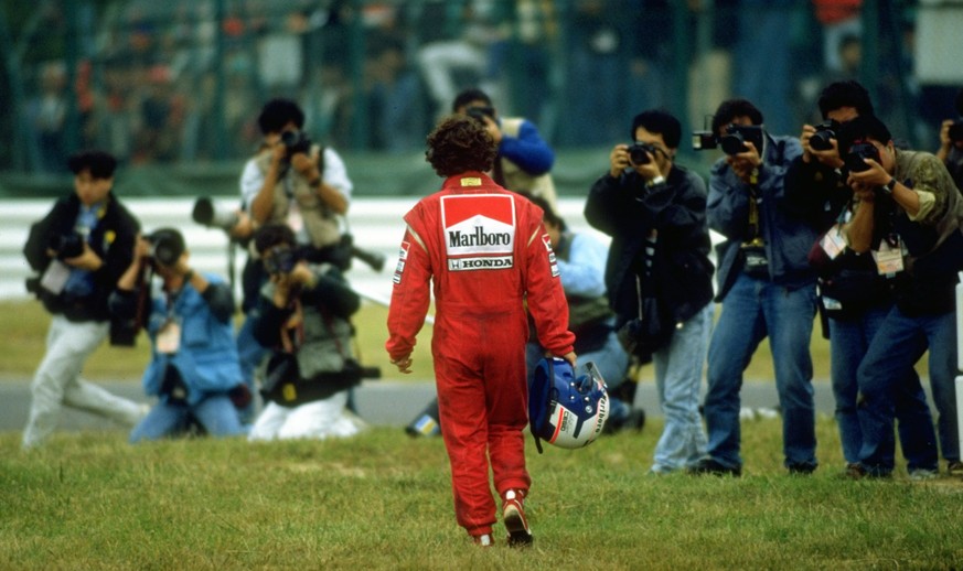 1989: McLaren Honda driver Alain Prost of France walks back to the pits during the Japanese Grand Prix at the Suzuka circuit in Japan. Prost retired from the race after an accident with team mate Ayrt ...