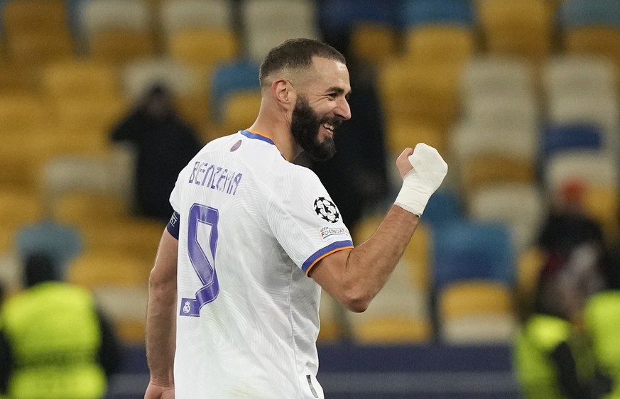 Real Madrid&#039;s Karim Benzema celebrates after scoring his side&#039;s fifth goal during the Champions League group D soccer match between Shakhtar Donetsk and Real Madrid at the Olympiyskiy stadiu ...