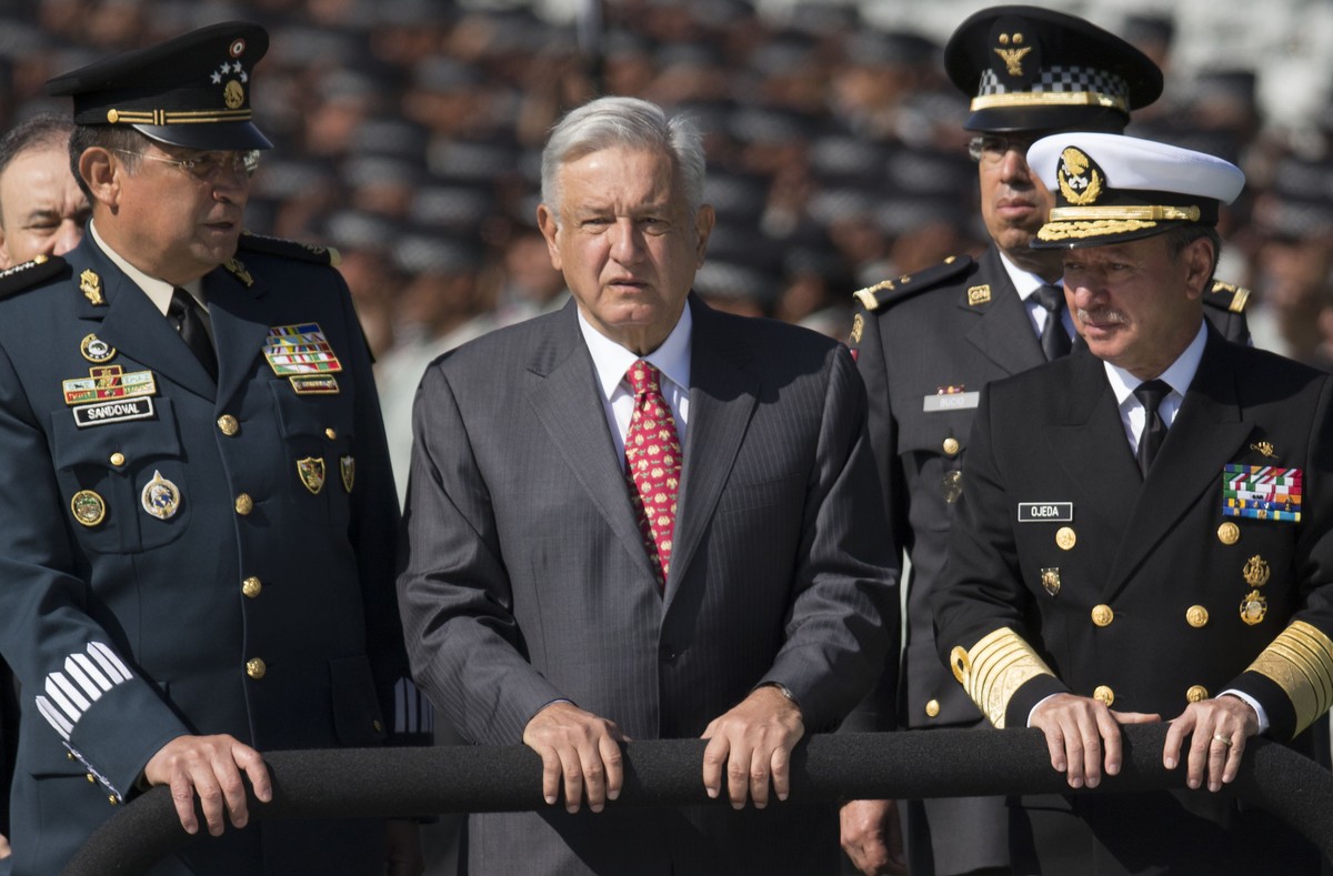 FILE - Mexican President Andres Manuel Lopez Obrador, flanked by Defense Secretary Gen. Luis Crescencio Sandoval, left, and Marine Secretary Jose Rafael Ojeda, surveys National Guard troops as the new ...