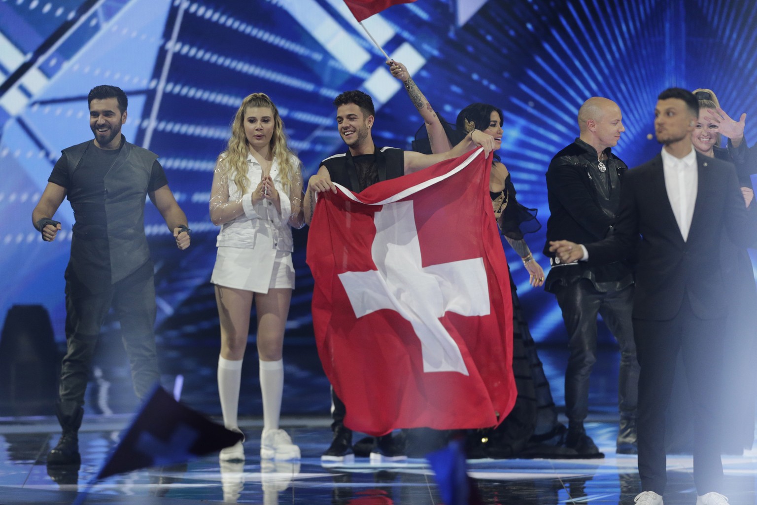 epa07577281 Contestant Luca Haenni of Switzerland (3-L) along with other finalists, stand on stage after the second Semi-Final of the 64th annual Eurovision Song Contest (ESC) at the Expo Tel Aviv, in ...