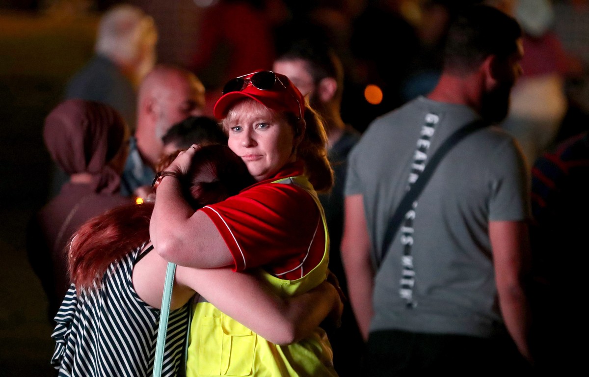epa07452818 A security guard comforts a young girl during a vigil to remember the victims of last week's terrorist attack on Christchurch's Al Noor Mosque and Linwood Islamic Centre in Adela ...