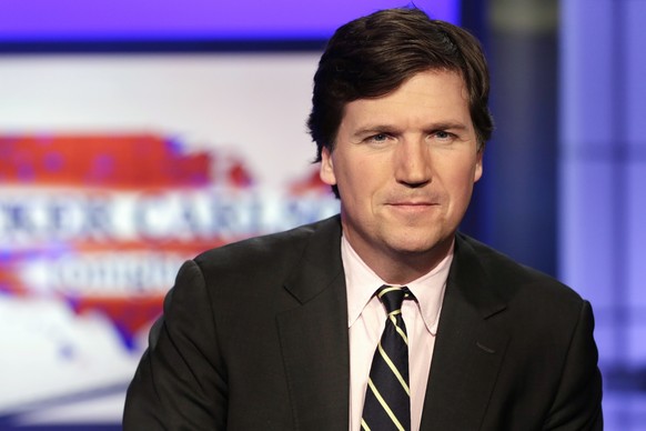 FILE - Tucker Carlson, host of &quot;Tucker Carlson Tonight,&quot; poses for photos in a Fox News Channel studio on March 2, 2017, in New York. A racist text message from Tucker Carlson is what helped ...