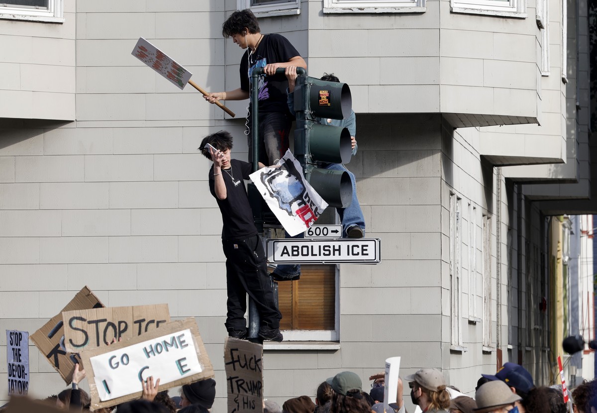epaselect epa12693680 Anti-ICE protestors climb a street signal light at a rally during a nationwide general strike demonstration at Mission Dolores Park in San Francisco, California, USA, 30 January  ...