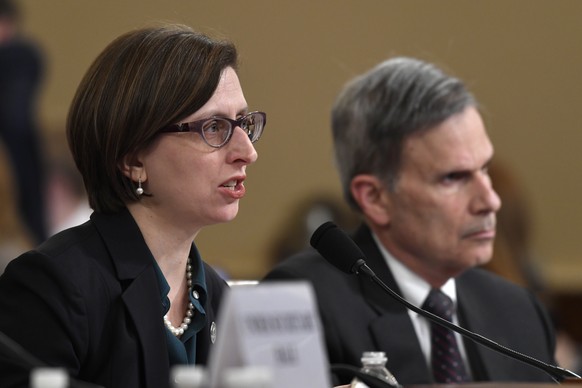 Deputy Assistant Secretary of Defense Laura Cooper, left, testifies before the House Intelligence Committee on Capitol Hill in Washington, Wednesday, Nov. 20, 2019, during a public impeachment hearing ...