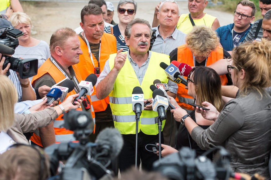 epa05489319 Andreas Richter (2-L) and Piotr Koper (L) and their spokesman Andrzej Gaik (C) speak to journalists near the site where they attempt to explore the existence of the so-called &#039;Nazi Go ...