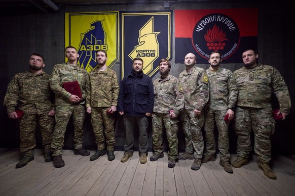 In this photo provided by the Ukrainian Presidential Press Office, Ukrainian President Volodymyr Zelenskyy, center, pose for a photo with servicemen near the frontline city of Pokrovsk, Donetsk region ...