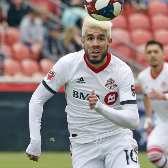 Toronto FC midfielder Alejandro Pozuelo (10) and Real Salt Lake midfielder Kyle Beckerman (5) battle for the ball during the first half of an MLS soccer match Saturday, May 18, 2019, in Sandy, Utah. ( ...