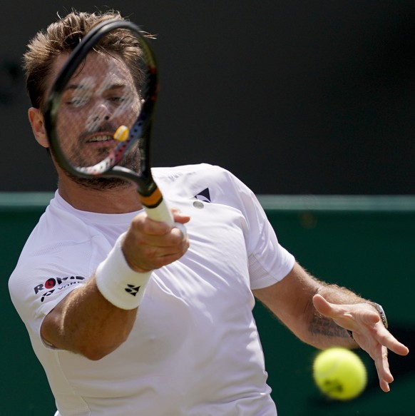 epa07691997 Stan Wawrinka of Switzerland in action against Reilly Opelka of the USA in their second round match during the Wimbledon Championships at the All England Lawn Tennis Club, in London, Brita ...