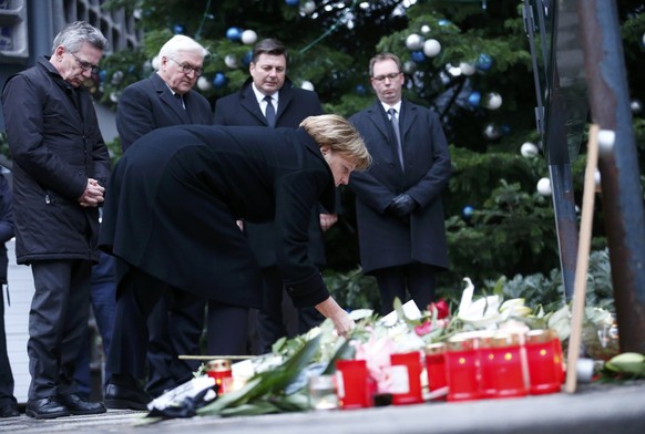 German Chancellor Angela Merkel lays flowers at the Christmas market in Berlin, Germany, December 20, 2016, one day after a truck ploughed into a crowded Christmas market in the German capital. REUTER ...