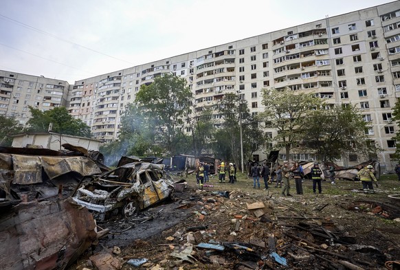 epa11340659 Ukrainian rescuers work at the site of a shelling of a residential area in Kharkiv, Ukraine, 14 May 2024 amid the Russian invasion. More than 1000 windows were broken and at least 21 peopl ...