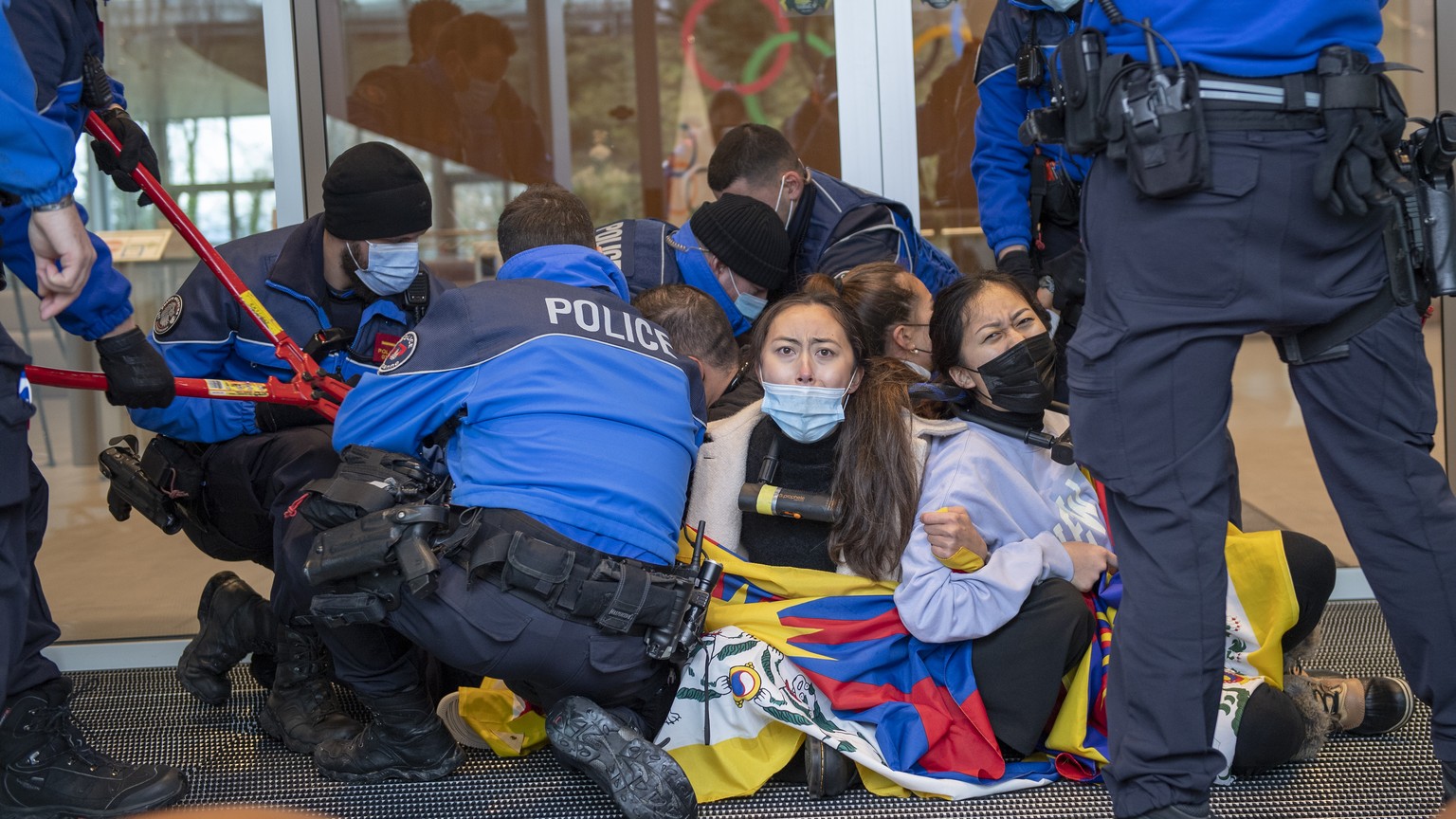 Protesters hold Tibetan flags during a protest against Beijing 2022 Winter Olympics by activists of the Tibetan Youth Association in Europe front of the International Olympic Committee, IOC, headquart ...