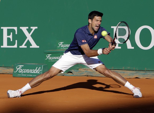 Serbia&#039;s Novak Djokovic returns the ball to Spain&#039;s Pablo Carreno Busta, during their third round match of the Monte Carlo Tennis Masters tournament in Monaco, Thursday, April, 20, 2017. (AP ...