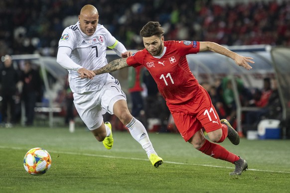 epa07458631 Geogia's Jaba Kankava (L) fights for the ball against Switzerland's Renato Steffen (R) during the UEFA Euro 2020 qualifier Group D soccer match between Georgia and Switzerland at ...