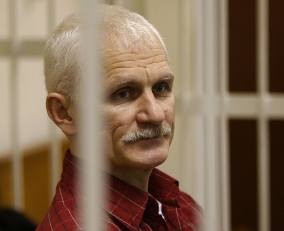 FILE - Ales Bialiatski, the head of Belarusian Viasna rights group, stands in a defendants&#039; cage during a court session in Minsk, Belarus, on Nov. 2, 2011. Activist Ales Bialiatski, who shared th ...