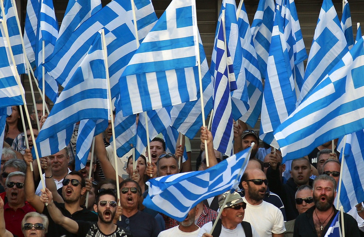 Supporters of the extreme far-right Golden Dawn party shout slogans during a protest in solidarity of the arrested lawmakers in front of the headquarters of Greek Police, in Athens, Saturday, Sept. 28 ...