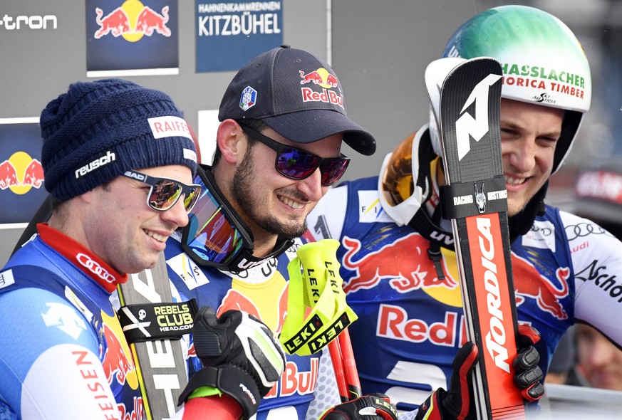 epa07318071 Dominik Paris (C) of Italy, Beat Feuz (L) of Switzerland, and Otmar Striedinger (R) of Austria react in the finish area during the men&#039;s Downhill race of the FIS Alpine Skiing World C ...