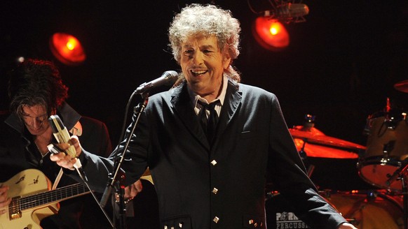 FILE - Bob Dylan performs in Los Angeles on Jan. 12, 2012. Dylan has a new book coming out this fall, a collection of more than 60 essays about songs and songwriters he admires, from Stephen Foster to ...