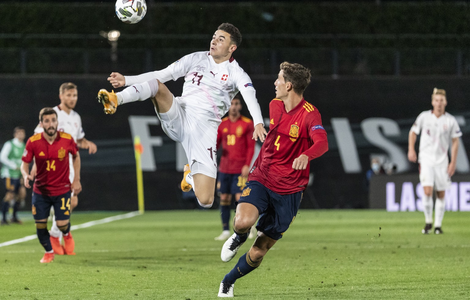 Switzerland&#039;s Ruben Vargas, left, fights for the ball against Spain