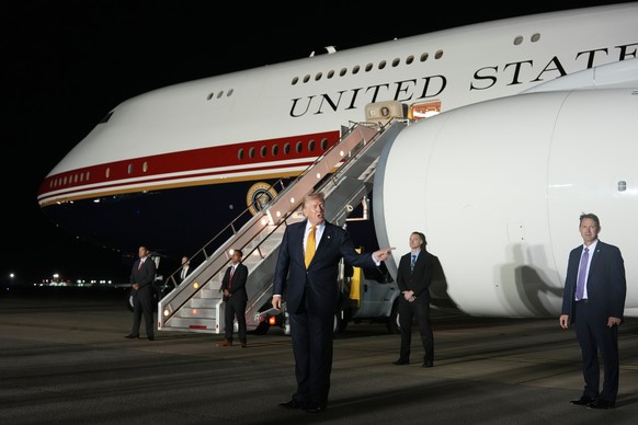 President Donald Trump speaks while switching planes at U.S. Air Force Base, RAF Mildenhall in Suffolk Eastern England, on his way back to Washington from the NATO summit in Ankara, Turkey, Wednesday, ...