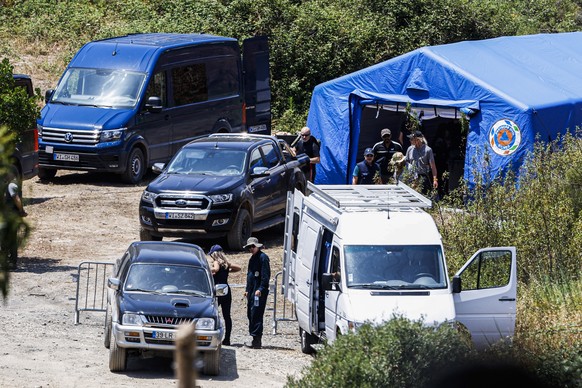 epa10652924 Authorities gather at an improvised base camp of the Judicial Police (PJ) in the Arade dam area, Faro district, during the new search operation during the investigation into the disappearance of Mad ...