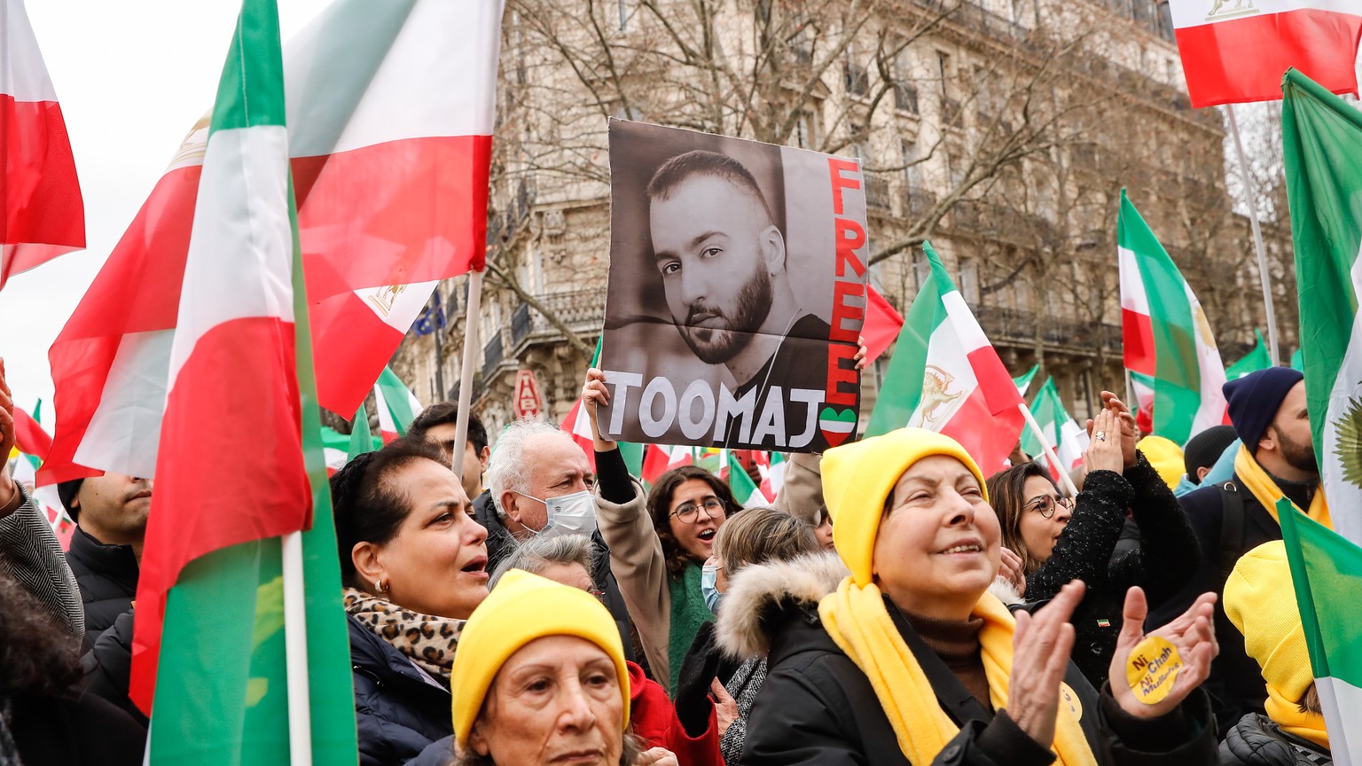 epa10463068 A woman holds a portrait of Iranian hip hop artist Toomaj Salehi, one of the main voices of the Iranian revolution, during a demonstration on the 44th anniversary of the Iranian revolution ...